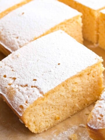 keto lemon bars sliced and topped with powdered sweetener