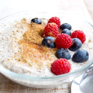 keto porridge in a bowl with sweetener and berries