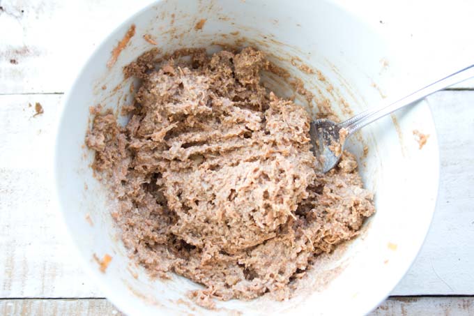 Carrot cake batter in a bowl with a fork.