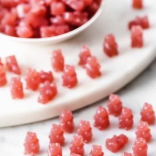 a little army of triple berry sugar free gummy bears in a bowl and on a table