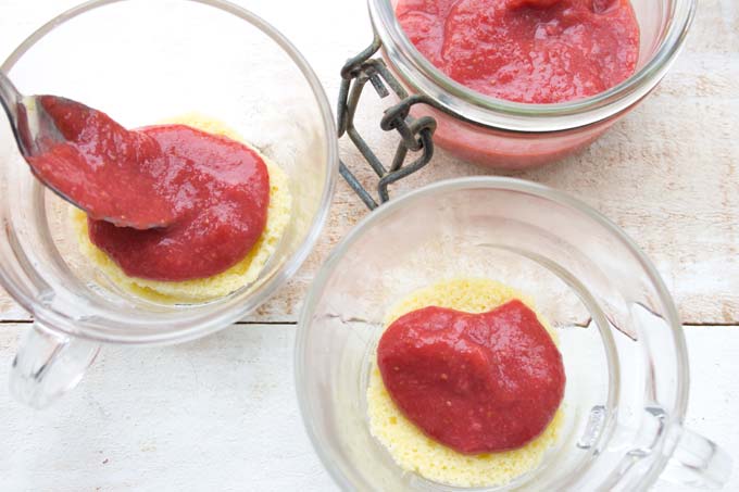 adding sugar free strawberry jam on top of a sugar free shortcake layer