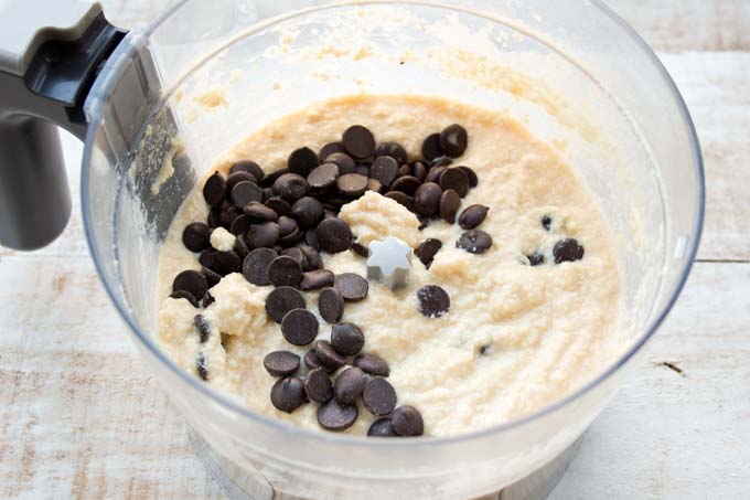 muffin batter and chocolate chips inside a food processor bowl