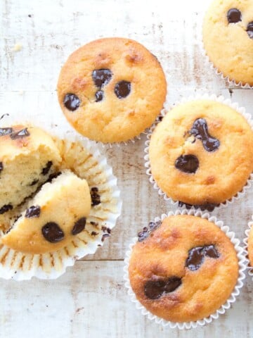 almond flour muffins with chocolate chips on a white wooden surface