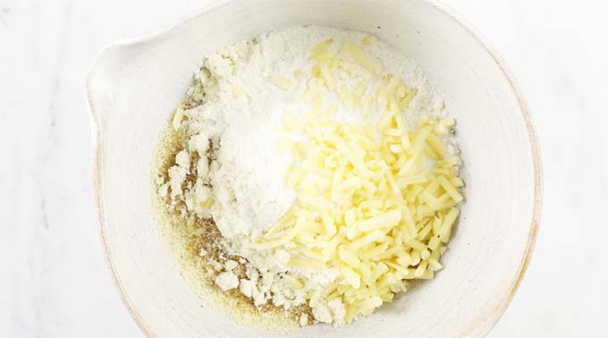 All dry ingredients for Kato cornbread in a white mixing bowl