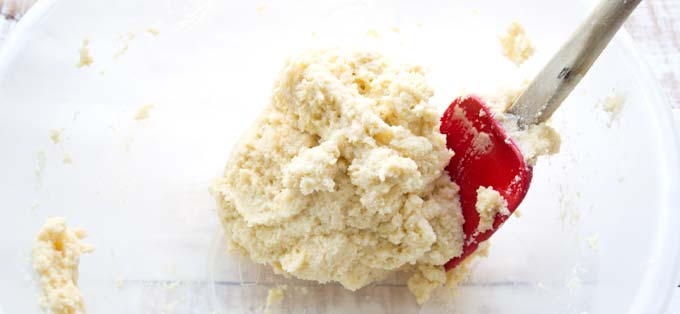 bread dough and a red spatula in a bowl