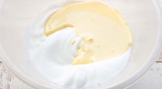 stiff egg white and beaten egg yolk in a mixing bowl