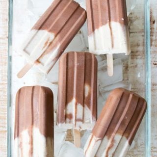 peanut butter and chocolate popsicles in a glass bowl on ice