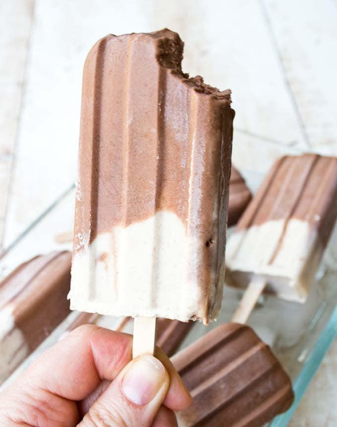 a peanut butter chocolate popsicle with the right corner bitten off