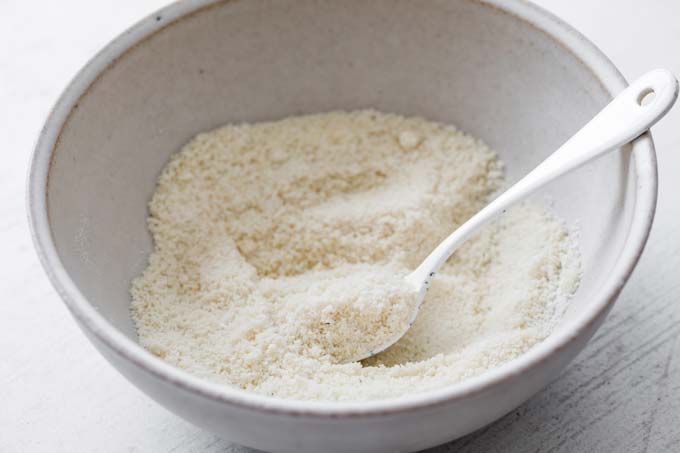 dry ingredients for almond crumb in a bowl with a spoon