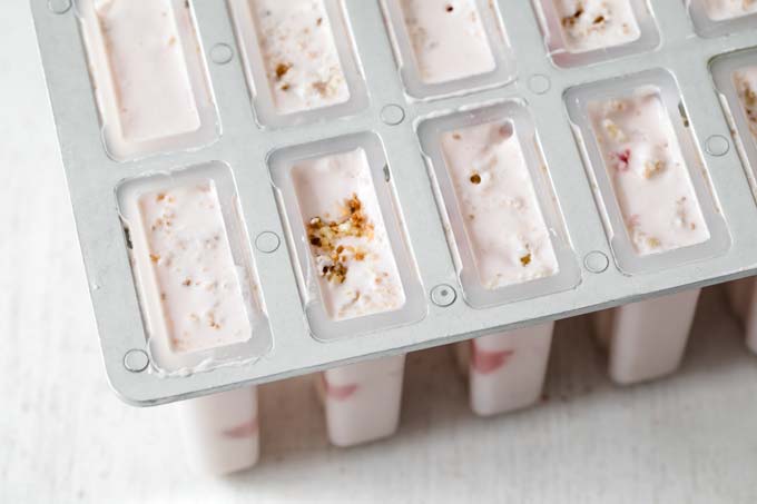 a mould with sugar free strawberry cheesecake ice pops