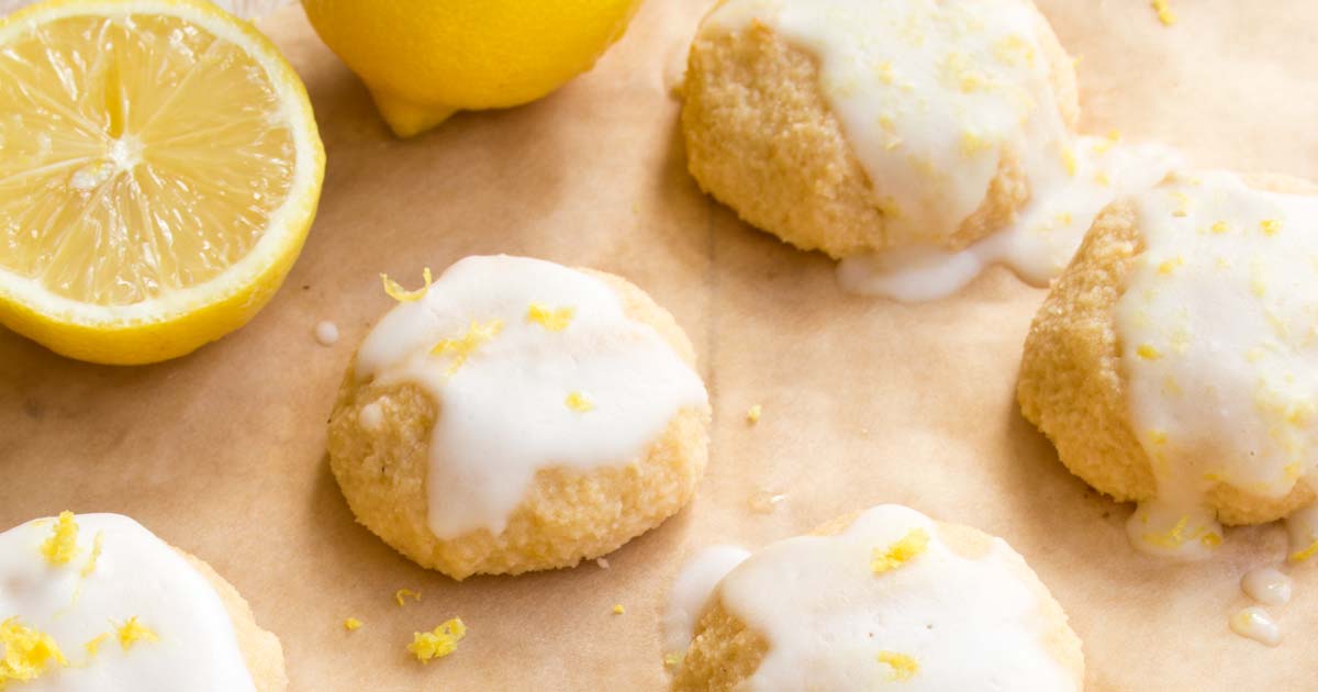 lemon cookies with a white glaze and lemon halves
