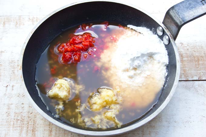 chopped red chilli, garlic, ginger and sweetener in a frying pan with vinegar