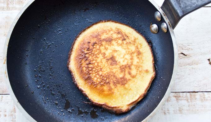 A cooked pancake in a frying pan