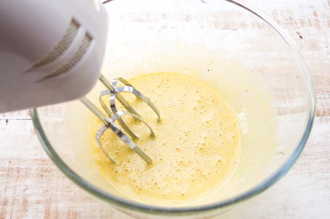 mixing egg yolk and sweetener with an electric blender