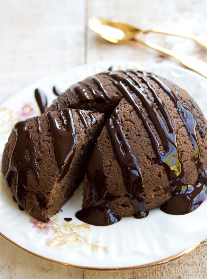 A round chocolate cake for 2 on a plate. 