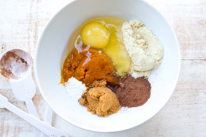Ingredients for a pumpkin mug cake in a white bowl