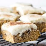 healthy pumpkin bars with cream cheese frosting on a cooling rack