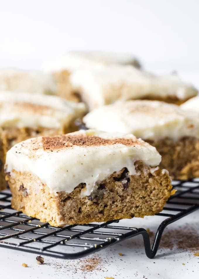 healthy pumpkin bars with cream cheese frosting on a cooling rack