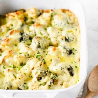 keto mac and cheese in a casserole dish with a wooden spoon