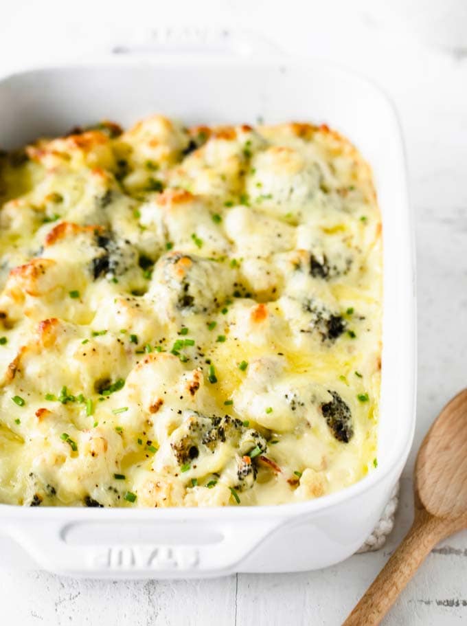 keto mac and cheese in a casserole dish with a wooden spoon