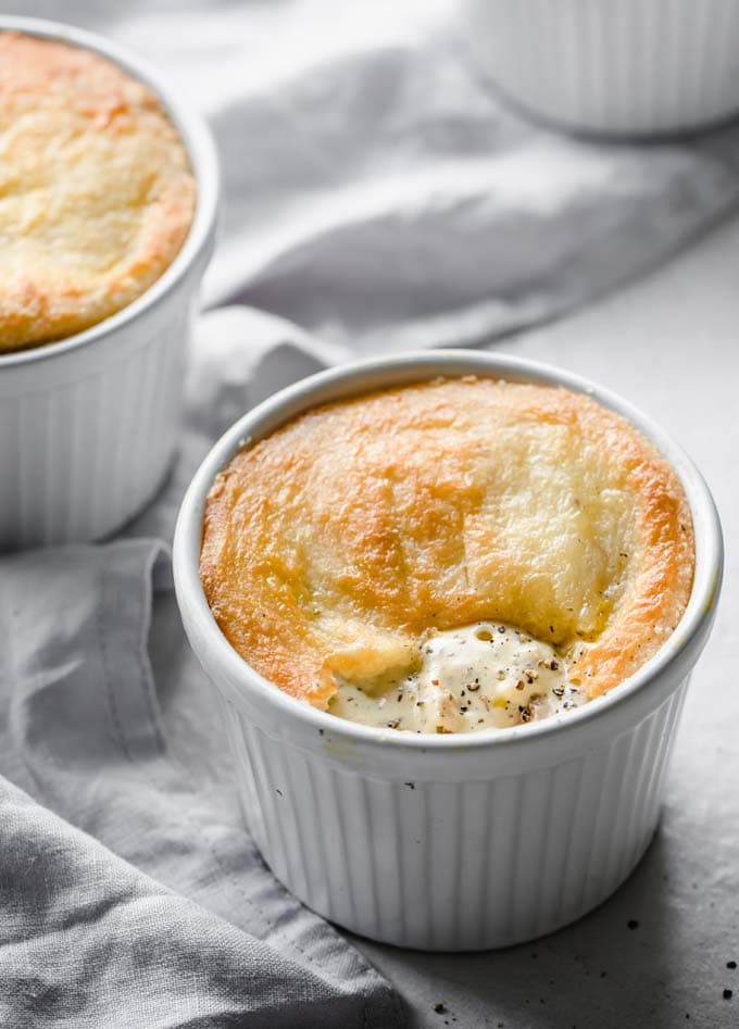a low carb chicken pot pie in a white ramekin topped with a fathead dough crust