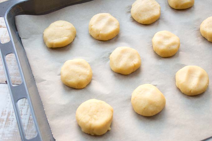 Unbaked biscuits on a baking sheet.