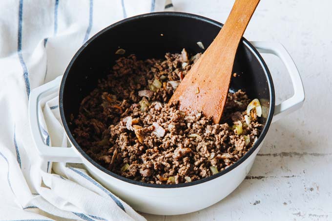 Browning ground beef in a saucepan.