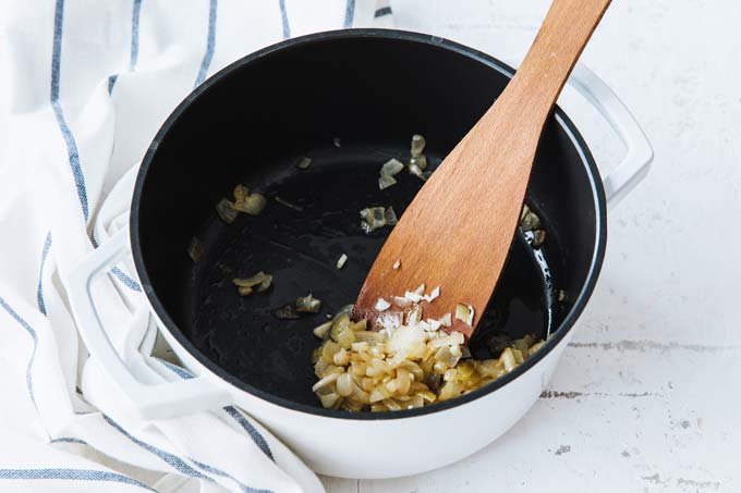 Frying onions in a saucepan.