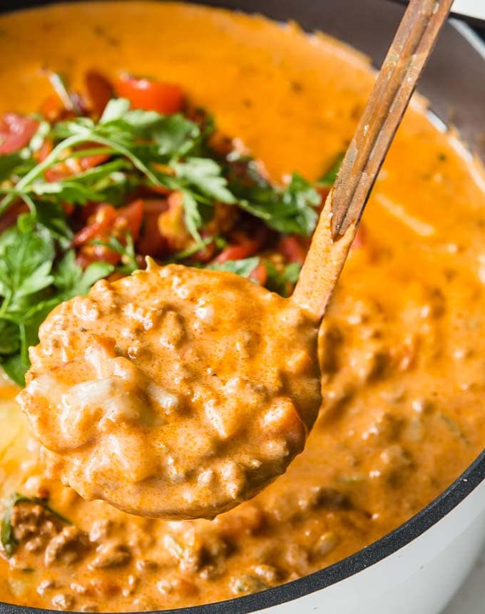 a ladle filled with creamy cheeseburger soup