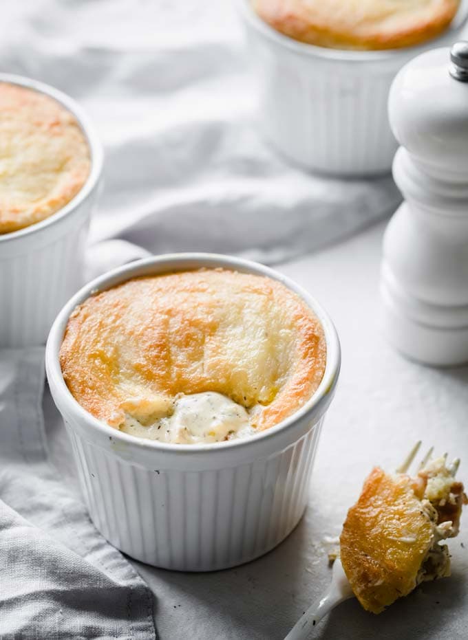 Individual pot pie with a fathead dough crust and a fork with a bite of pie.
