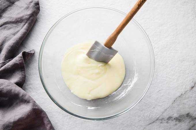 Melted mozzarella and cream cheese in a glass bowl.