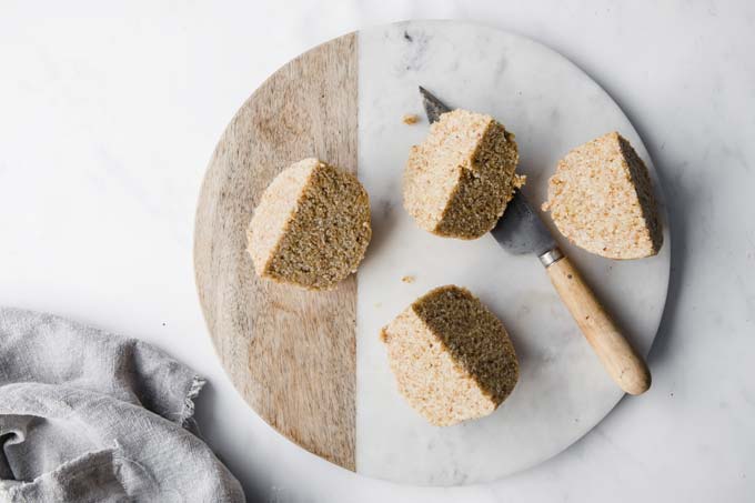 dough quarters on a cutting board and a knife 