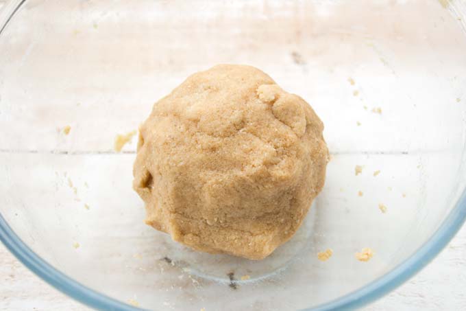 A ball of cookie dough in a bowl.