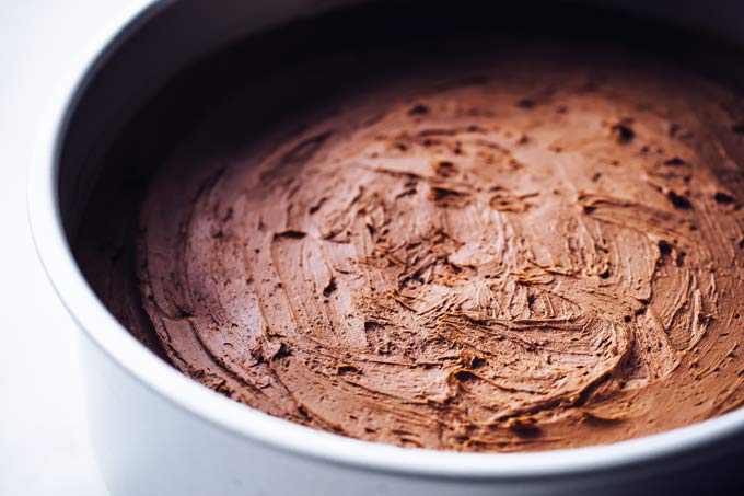 chocolate cheesecake mix spread in a springform dish