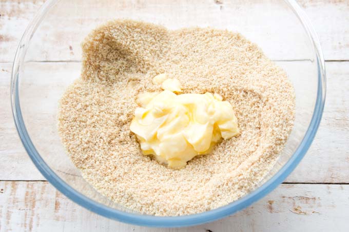 Mixed dry ingredients and soft butter in a mixing bowl.