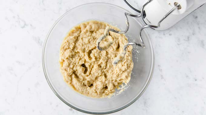 almond flour dough in a glass bowl and dough hooks