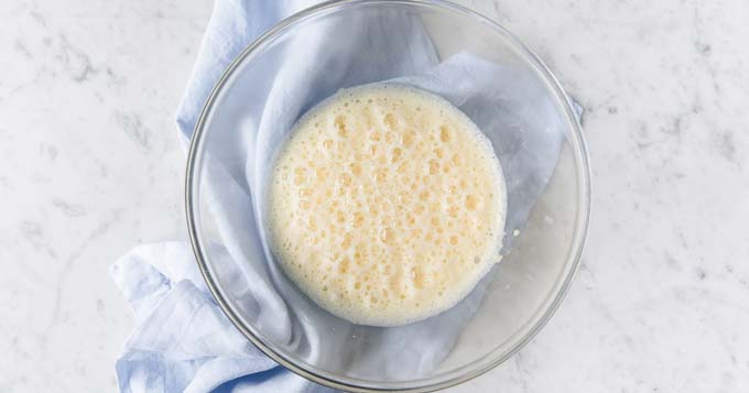 wet ingredients for a dough in a glass bowl