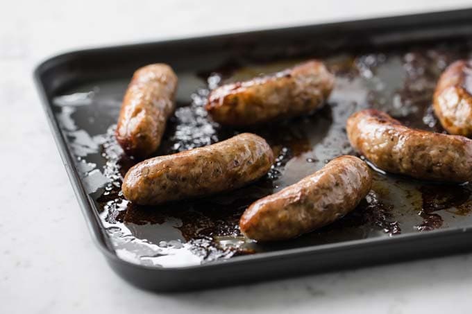 grilled sausages on a baking sheet