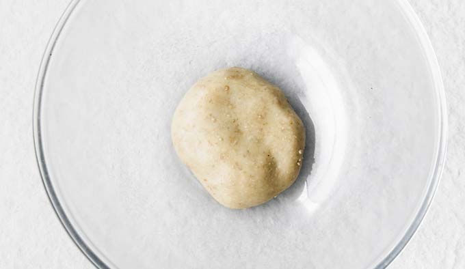 mozzarella and sesame seed dough in a glass bowl