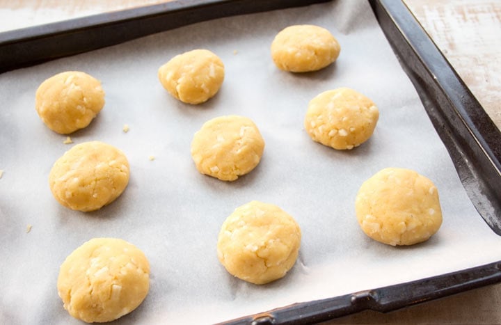 unbaked biscuits on a baking tray lined with parchment paper