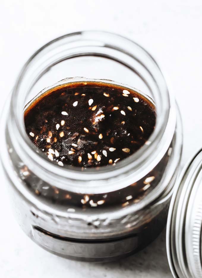 sugar free teriyaki sauce with sesame seeds in a glass jar