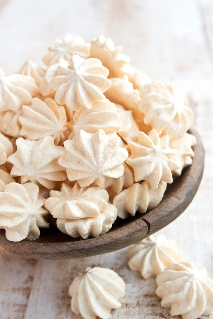 piped small sugar free meringues heaped in a bowl