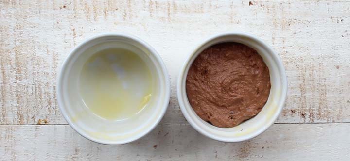 two ramekins, the left empty with melted butter, the right with chocolate dough