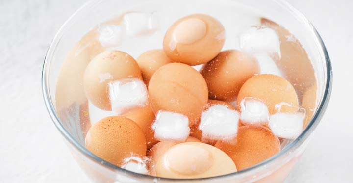 boiled eggs in a bowl with ice water