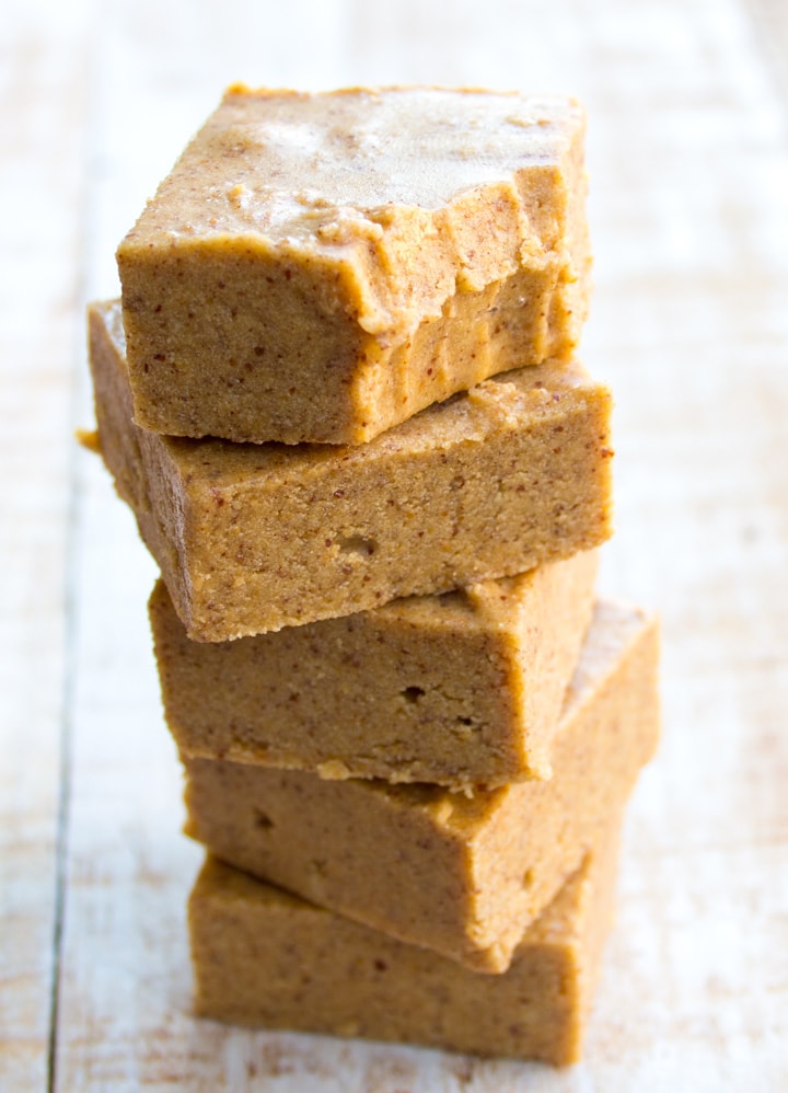 a stack of keto peanut butter fudge, the top square with teethmarks