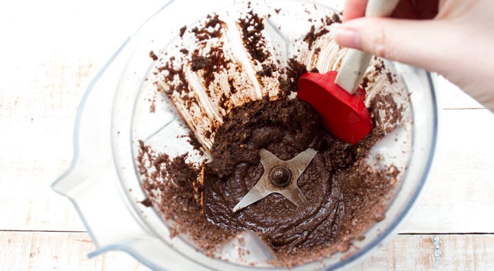 scraping nutella down the sides of a blender bowl with a spatula