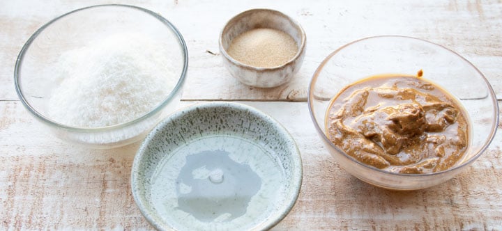 4 bowls with almond butter, shredded coconut, coconut oil and granular erythritol