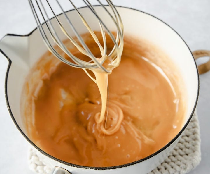 Caramel dripping off the balloon whisk. 