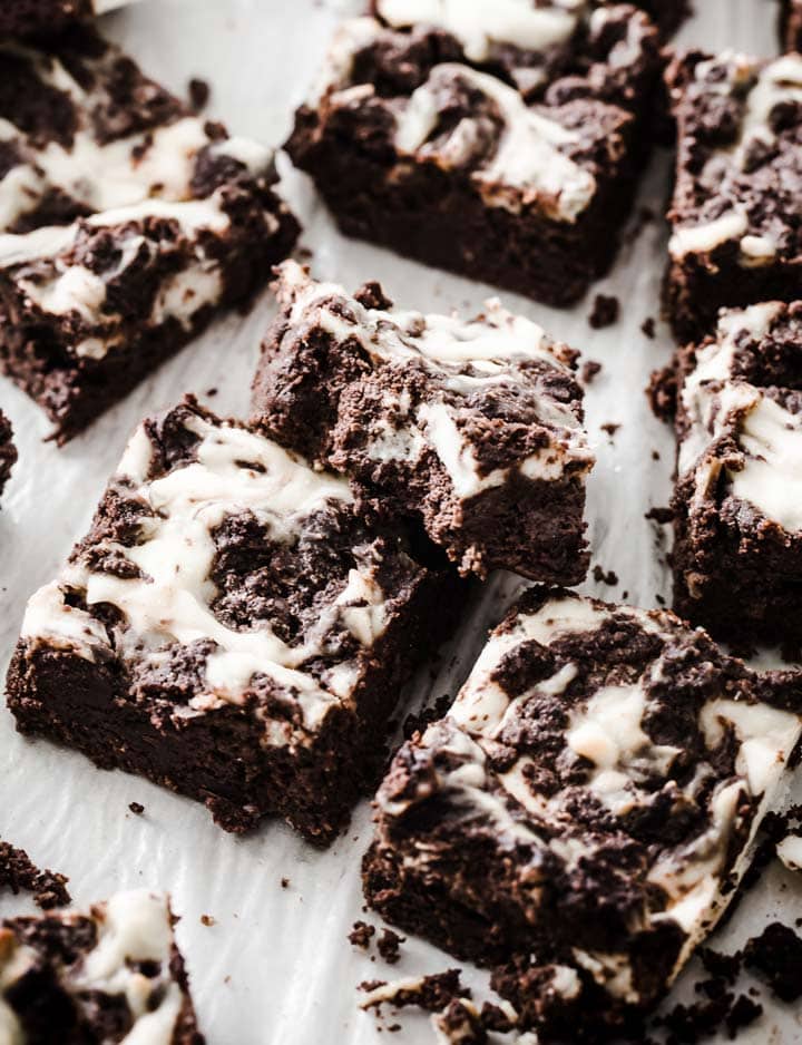 keto cheesecake brownies squares on parchment paper