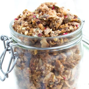 An open glass jar filled with keto granola.